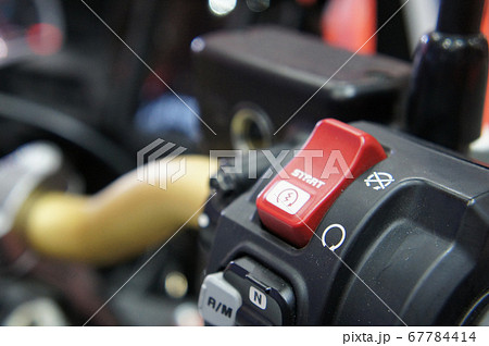 KUALA LUMPUR, MALAYSIA -JULY 25, 2019: Motorcycle ignition and engine kill button. Placed at the right-hand side of the motorcycle handle. It is usually red. 67784414