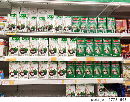 KUALA LUMPUR, MALAYSIA -JUNE 4, 2020: Processed coconut milk packed in the small commercial paper box and displayed for sale on a steel rack inside the supermarket. Sorted by brand. KUALA LUMPUR, MALAYSIA -JUNE 4, 2020: Processed coconut milk packed in the small commercial paper box and displayed for sale on a steel rack inside the supermarket. Sorted by brand. 67784643