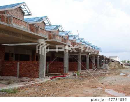 SEREMBAN, MALAYSIA -APRIL 07, 2020: New double story luxury terrace house under construction in Malaysia.  Designed by an architect with a modern and contemporary style.  67784836
