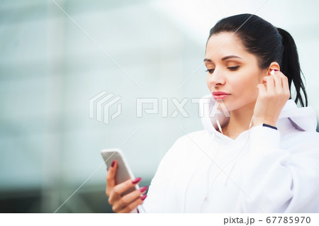 Fitness woman doing workout standing in a stadium background. 67785970