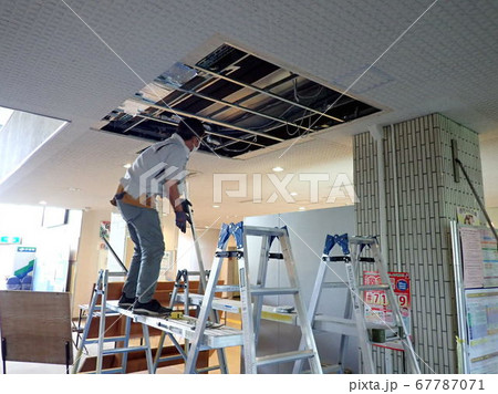 空調工事のために天井補修する設備業者 67787071
