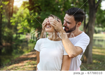 young lovely couple caucasian in white dress playing blindfolded with happy face and laughing 67788310