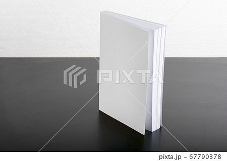 Book with blank cover on black background mock-up 67790378