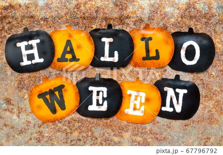 Black and orange pumpkins on rust stains texture Black and orange pumpkins on rust stains texture 67796792
