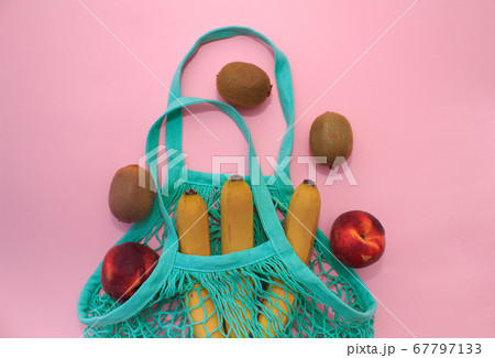 Cotton green string bag on pink background Cotton green string bag on pink background 67797133
