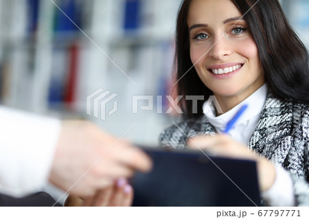 Man hold folder in his hand and give to doctor prescription for signature. 67797771