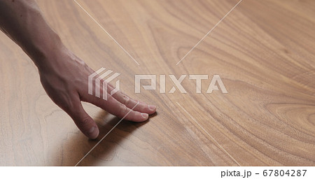 man hand touches black walnut dining table surface man hand touches black walnut dining table surface 67804287