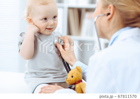 Doctor and patient in hospital. Little girl is being examined by doctor with stethoscope. Medicine concept 67811570