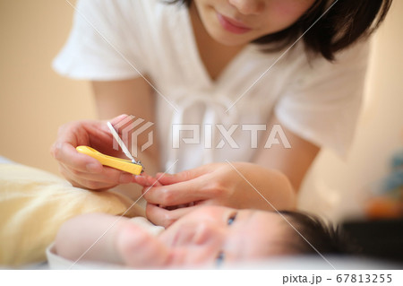 赤ちゃんの爪を切る母親 67813255