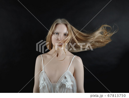 Conceptual portrait of a young blonde girl with 67813750