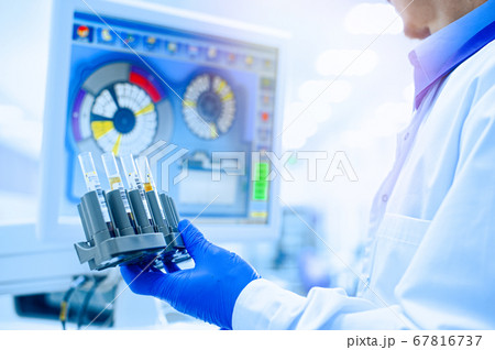 Laboratory assistant in rubber gloves working with Laboratory assistant in rubber gloves working with 67816737