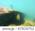 Concrete block under water. Reflection of sun rays under water on a stone. 67816752