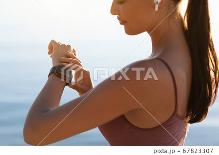 Close up of girl looking at hand with smart watch 67823307