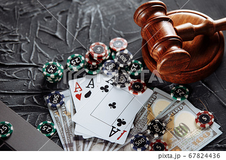 Concept of legal regulation of gambling, justice gavel and dice on the background of an old grey table 67824436