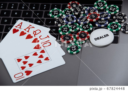 Online poker casino theme. Gambling chips and playing cards on laptop Online poker casino theme. Gambling chips and playing cards on laptop 67824448
