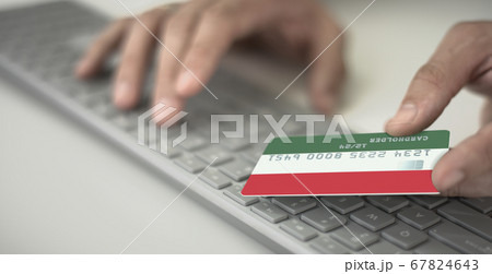 Man pays online with plastic bank card with printed flag of Hungary. Fictional numbers 67824643