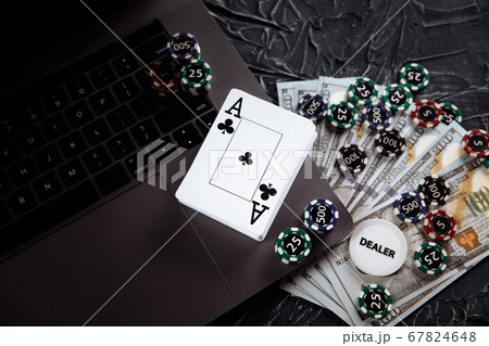 Poker cards and stacks of poker chips on a laptop computer. Poker online concept Poker cards and stacks of poker chips on a laptop computer. Poker online concept 67824648
