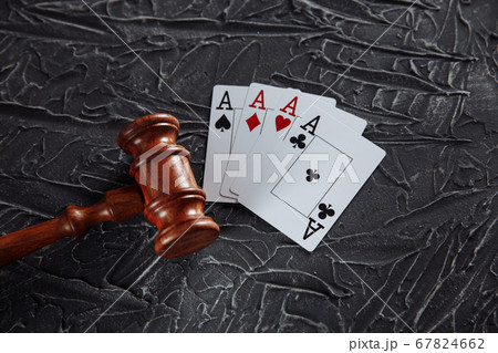 Law and rules for online gambling concept, judge gavel with playng cards on grey background Law and rules for online gambling concept, judge gavel with playng cards on grey background 67824662