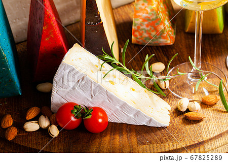 Cheese of elite variety sliced on a wooden board 67825289