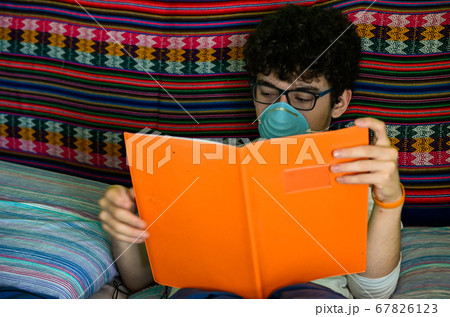 A bedridden Caucasian boy wears a blue protective A bedridden Caucasian boy wears a blue protective 67826123