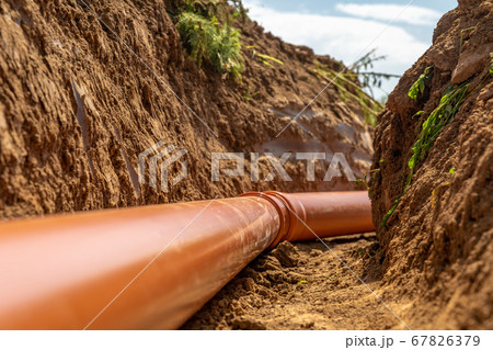 Plastic pipes in the ground during the construction of a building, bunner with copy space Plastic pipes in the ground during the construction of a building, bunner with copy space 67826379