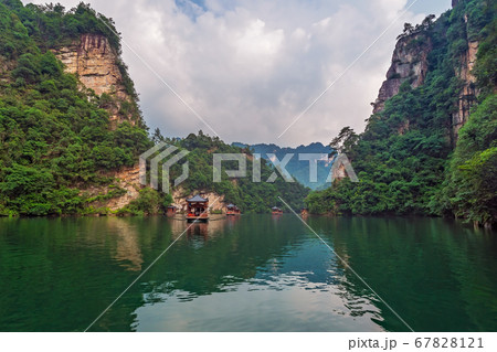 Tourist boat sailing among karst landscape on Tourist boat sailing among karst landscape on 67828121