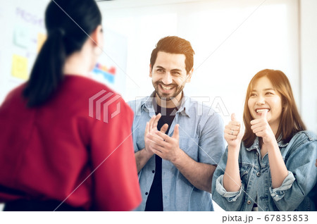 Happy group of business people clapping in office. 67835853