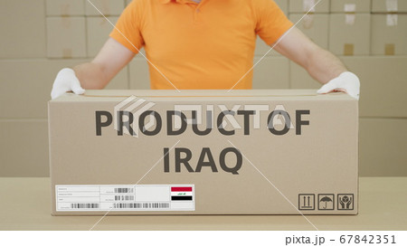PRODUCT OF IRAQ printed text on the side of a big cardboard box in a warehouse PRODUCT OF IRAQ printed text on the side of a big cardboard box in a warehouse 67842351