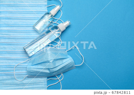 coronavirus COVID-19 pandemic concept - background made of antiviral surgical protective medical masks and alcohol hand sanitizer antiseptic for protection against corona virus coronavirus COVID-19 pandemic concept - background made of antiviral surgical protective medical masks and alcohol hand sanitizer antiseptic for protection against corona virus 67842811