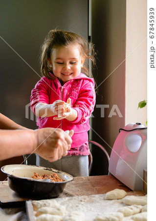 At home, granddaughter and grandmother cook At home, granddaughter and grandmother cook 67845939