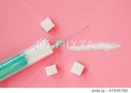 Syringe with granulated sugar inside. Syringe with granulated sugar inside. 67846789