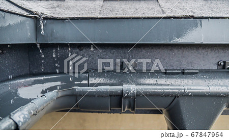 Jets of rain drain into the drainage system on the roof of the house Jets of rain drain into the drainage system on the roof of the house 67847964