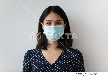 Headshot portrait of Asian woman in medical facemask Headshot portrait of Asian woman in medical facemask 67848582