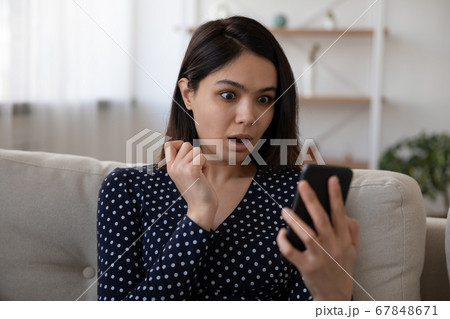 Shocked Vietnamese girl surprised by message on cellular 67848671