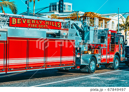 Beverly Hills area and fire trucks, hurry to fire. 67849497