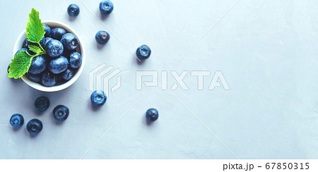 Fresh blueberries in a white bowl. 67850315