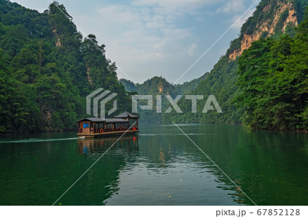 Tourist boat sailing among karst landscape on Tourist boat sailing among karst landscape on 67852128