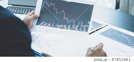 Trader businessmen analyze stock graph and report, Trader businessmen analyze stock graph and report, 67852961