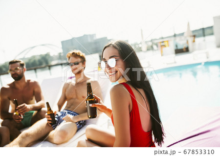 Brunette woman smiling positively spending with friends Brunette woman smiling positively spending with friends 67853310