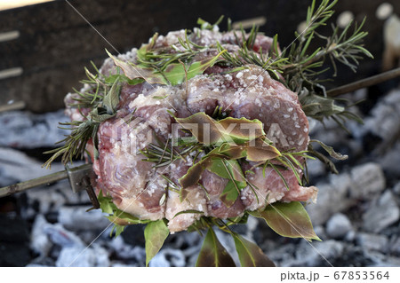 pork roast cooking on charcoal  on barbecue 67853564