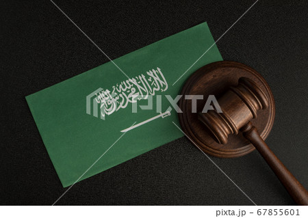 Wooden mallet justice on Saudi Arabia flag. Law Wooden mallet justice on Saudi Arabia flag. Law 67855601