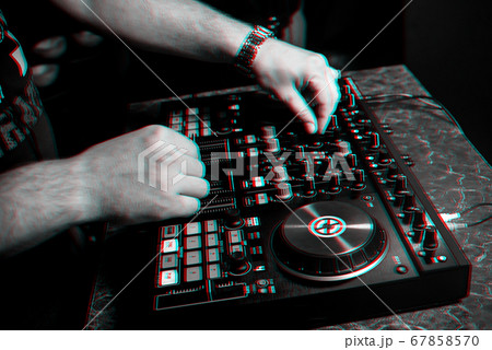DJ in a booth playing a mixer at a nightclub DJ in a booth playing a mixer at a nightclub 67858570