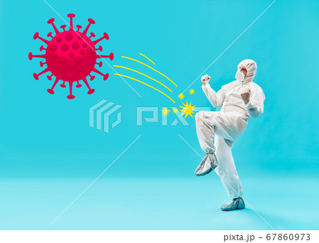 Doctor in PPE suit beat coronavirus on blue background Doctor in PPE suit beat coronavirus on blue background 67860973