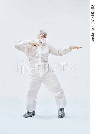 Full lenght portrait of happy dancing doctor in PPE suit on blue background Full lenght portrait of happy dancing doctor in PPE suit on blue background 67860982