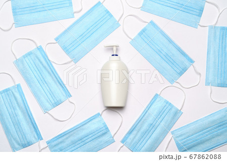 coronavirus COVID-19 pandemic concept - background made of antiviral surgical protective medical masks and alcohol hand sanitizer antiseptic for protection against corona virus coronavirus COVID-19 pandemic concept - background made of antiviral surgical protective medical masks and alcohol hand sanitizer antiseptic for protection against corona virus 67862088