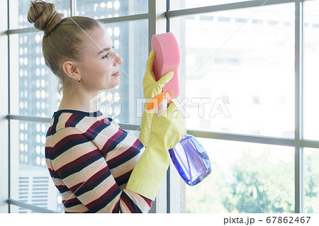 Young women cleaning the house 67862467