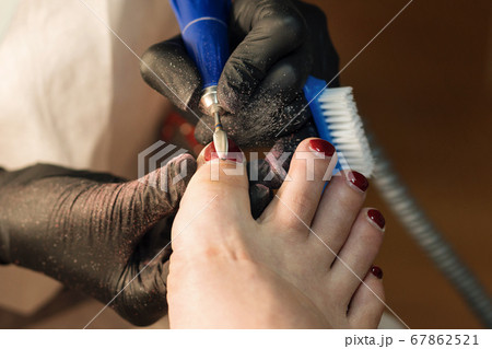 Pedicure removing old coating. Chiropody 67862521