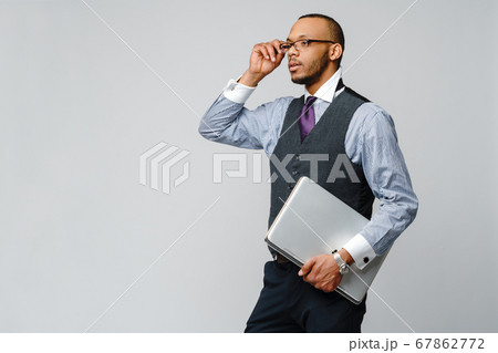professional african-american business man holding laptop computer professional african-american business man holding laptop computer 67862772