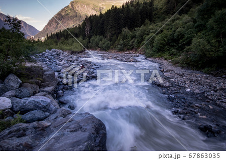 rushing blue river in a mountain forest rushing blue river in a mountain forest 67863035