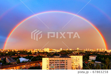 Large rainbow in the evening cityscape Large rainbow in the evening cityscape 67863258